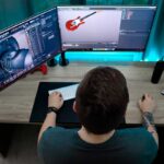 3d-modeling-software-on-2-computer-screens-on-a-desk-with-a-male-3d-modeling-artist